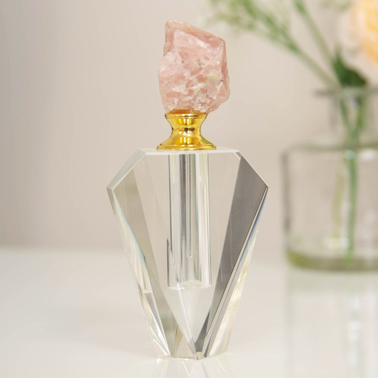 Estella Pink Stone & Glass Perfume Bottle A beautifully elegant cut crystal glass perfume bottle with pink rock crystal stopper top. From Estella by SOPHIA - Champagne Chic women's home and gift evoking the luxurious spirit of the art deco era.