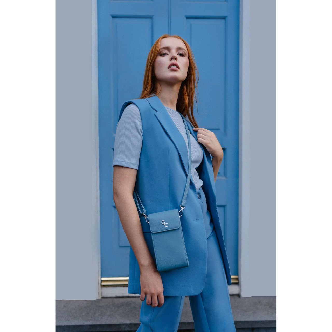 Mini Cross Body Bag - Light Blue by Galway Crystal Introducing the new must have accessory that is truly functional. Our Light weight, Slim, Sleek, Crossbody bag is designed to hold the most essential accessory: Your mobile phone. There is nothing more liberating than carrying a lightweight bag that carries your essentials.