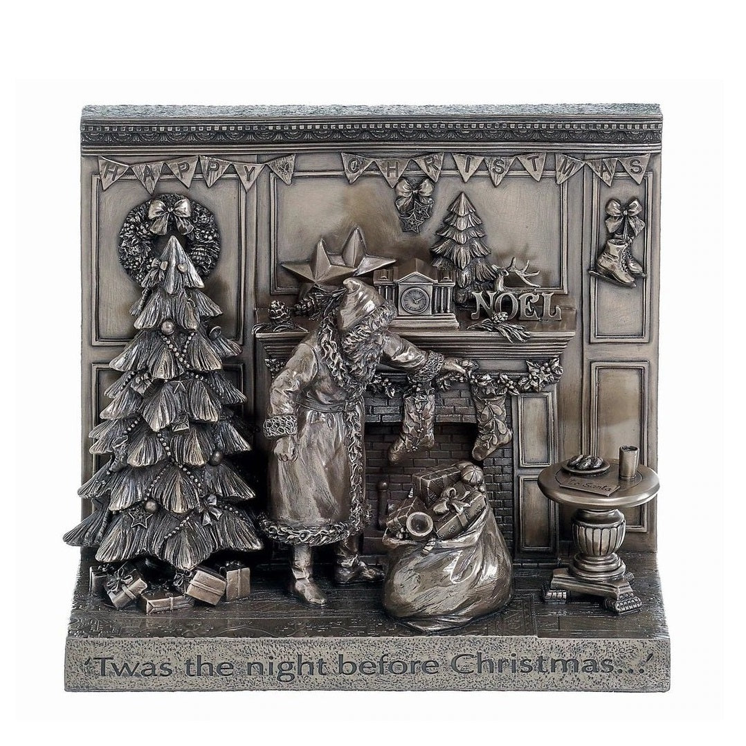 Genesis Twas the Night Before Christmas by Genesis Beautifully crafted in cold cast bronze, this Christmas scene incorporates father Christmas and his bag of toys filling the stockings for Christmas by the fireplace. The words " Twas the night before Christmas" crafted into the front of the scene, this Christmas display would make a wonderful gift.