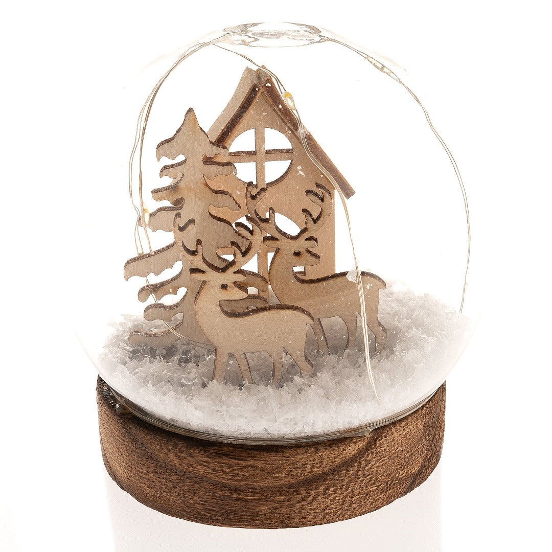 Glass Dome with Wooden Reindeers, Tree and House LED Imagine a walk through a dense dewy fir forest on a crisp winter morning.