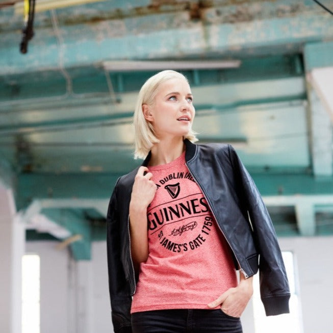 Guinness Red Grindle Stamp Ladies T-Shirt This red grindle ladies T-shirt is part of the Guinness Official Merchandise Collection. The shirt has a flock print stamp style label featuring St. James gate. It is a classic fit for style and comfort. - Official Guinness merchandise - Ladies fit t-shirt - Red - Pink