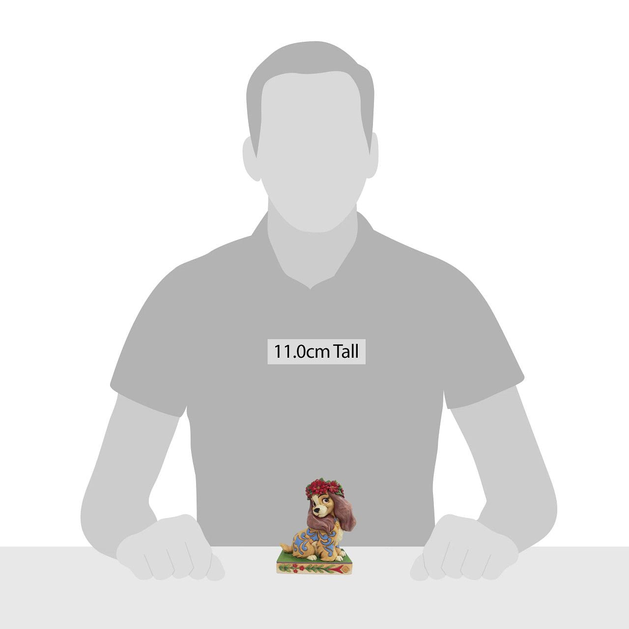 Jim Shore Christmas Lady Personality Pose Figurine Lady, the regal Cocker Spaniel, wears a crown of holly in this lovely relief by Jim Shore. Her classic blue collar is matched by gorgeous rosemaling running down her coat.