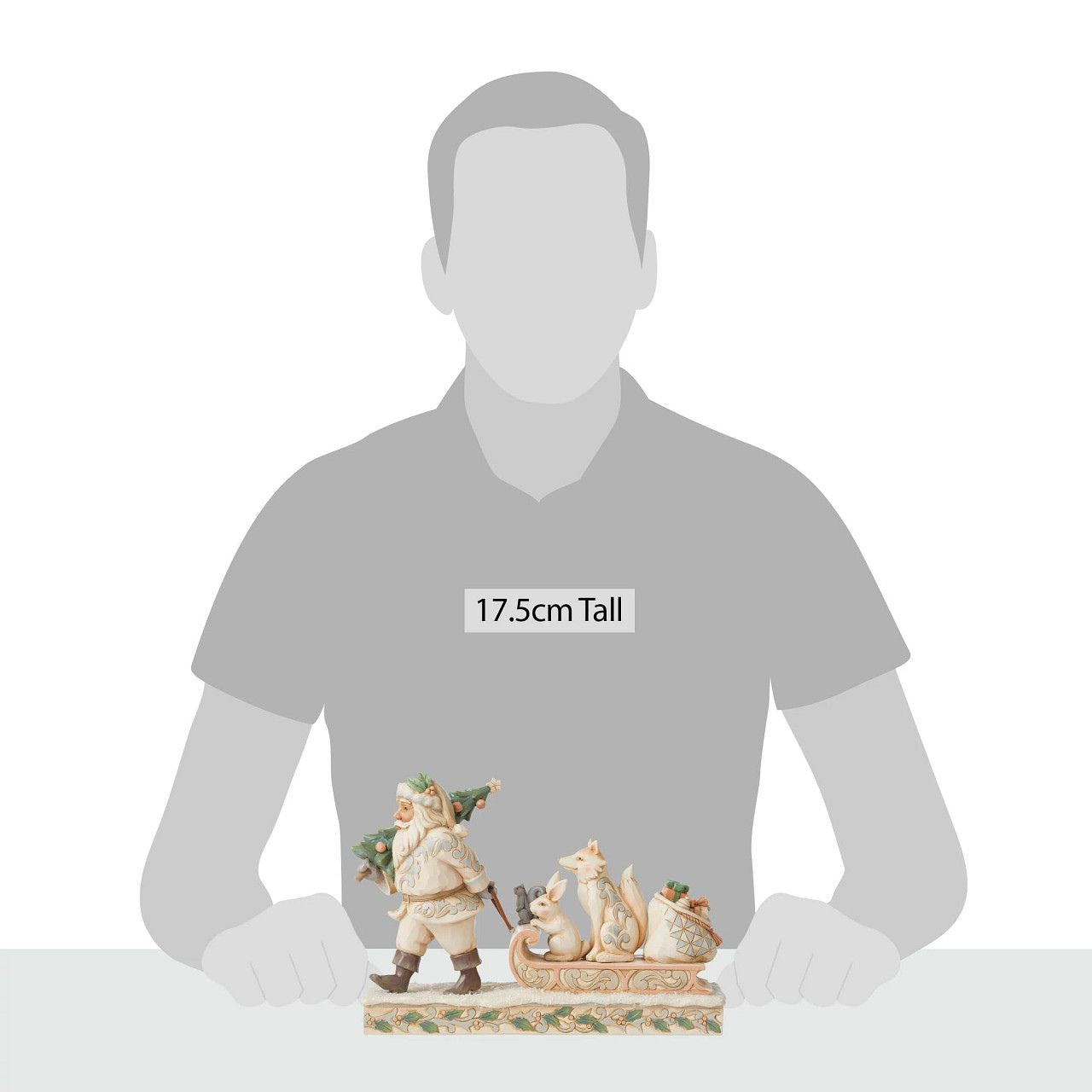 Jim Shore White Woodland Santa Pulling Sled Figurine "A Wandering We Go" Santa is getting ready for Christmas with his furry friends. This piece features Santa dressed in the iconic, muted colours of White Woodland, whilst pulling a sled of forest animals and gifts.