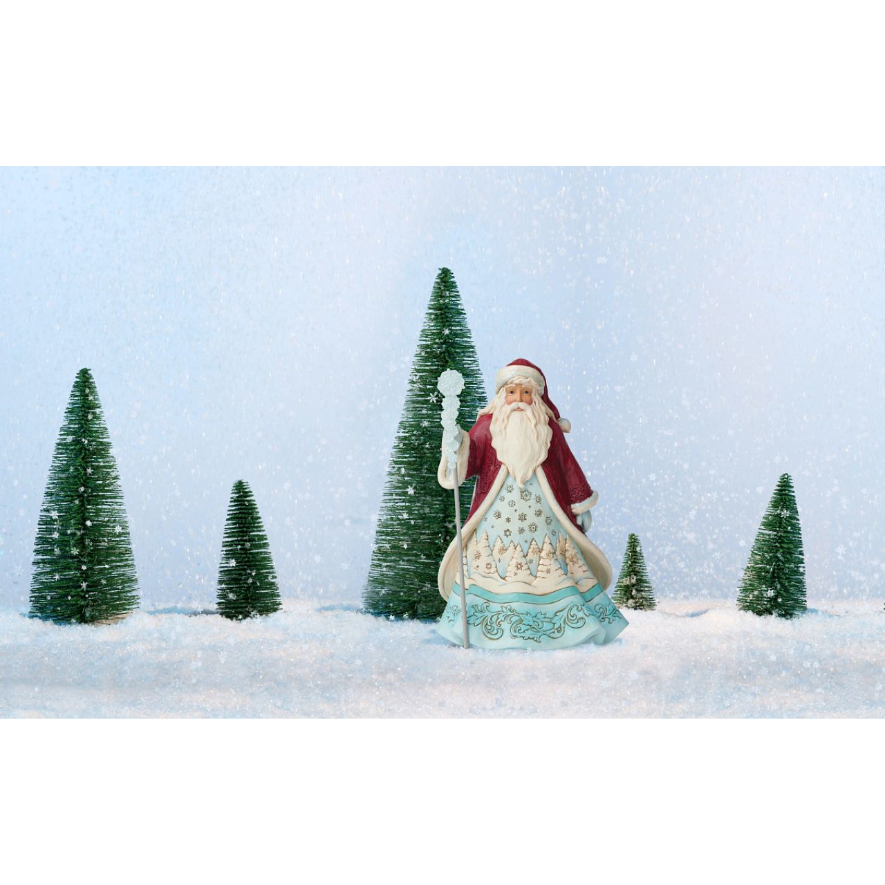 Jim Shore Winter Wonderland Santa with Snowflakes Figurine "Ice and Snow Can Warm The Soul" This icey Santa has been designed by Jim Shore as part of his Winter Wonderland collection. His staff is topped by an acrylic snowflake to add to the feeling of snow and ice before added emblishments of glitter are added.