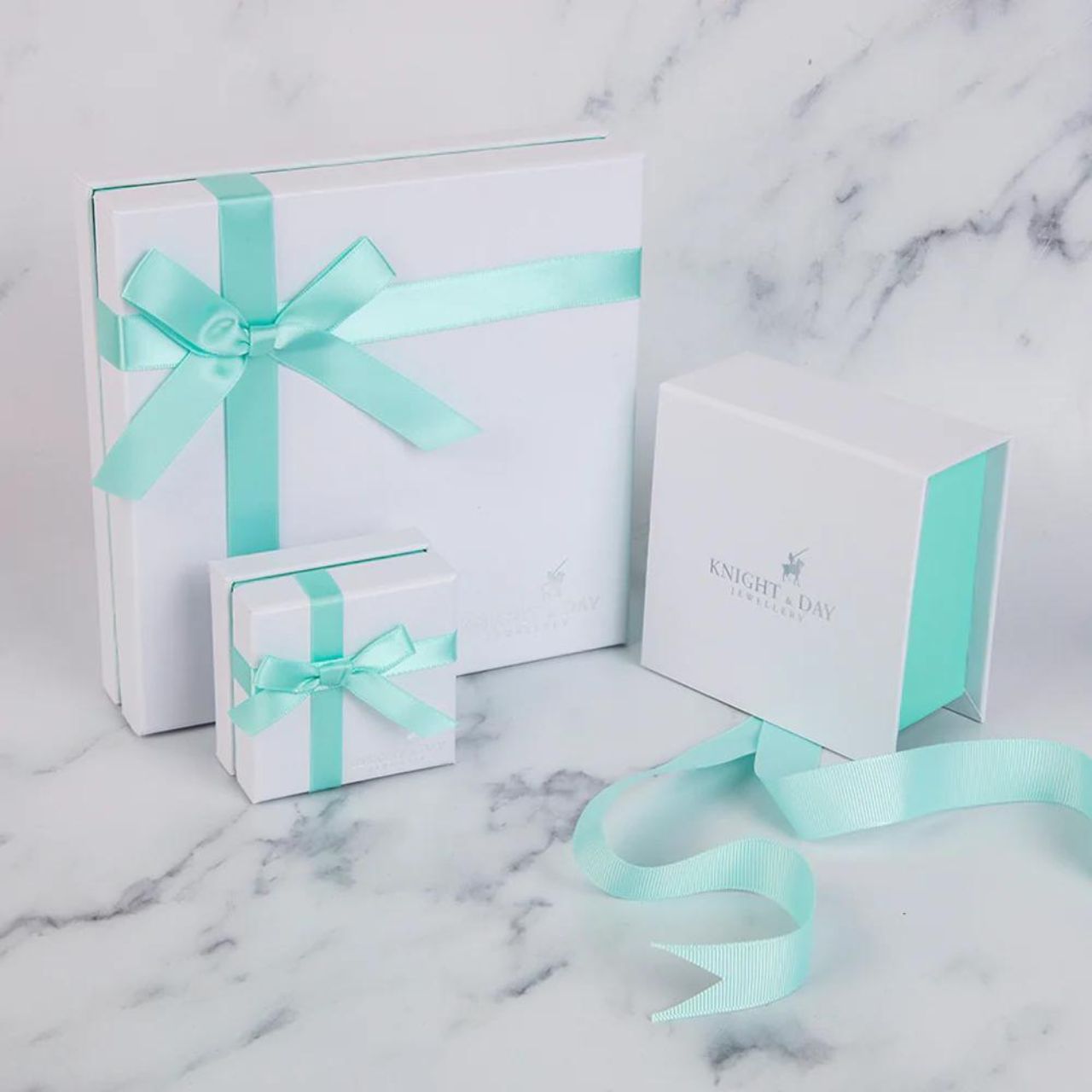 Blue Rhodium Bracelet by Knight & Day Classic style bracelet embellished with light blue CZ stones. Slider fastening. Rhodium plating.