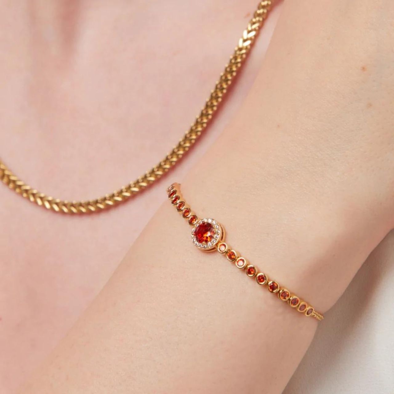 Knight & Day Classic Red Bracelet Classic style bracelet embellished with red CZ stones. Slider fastening. Gold plating.
