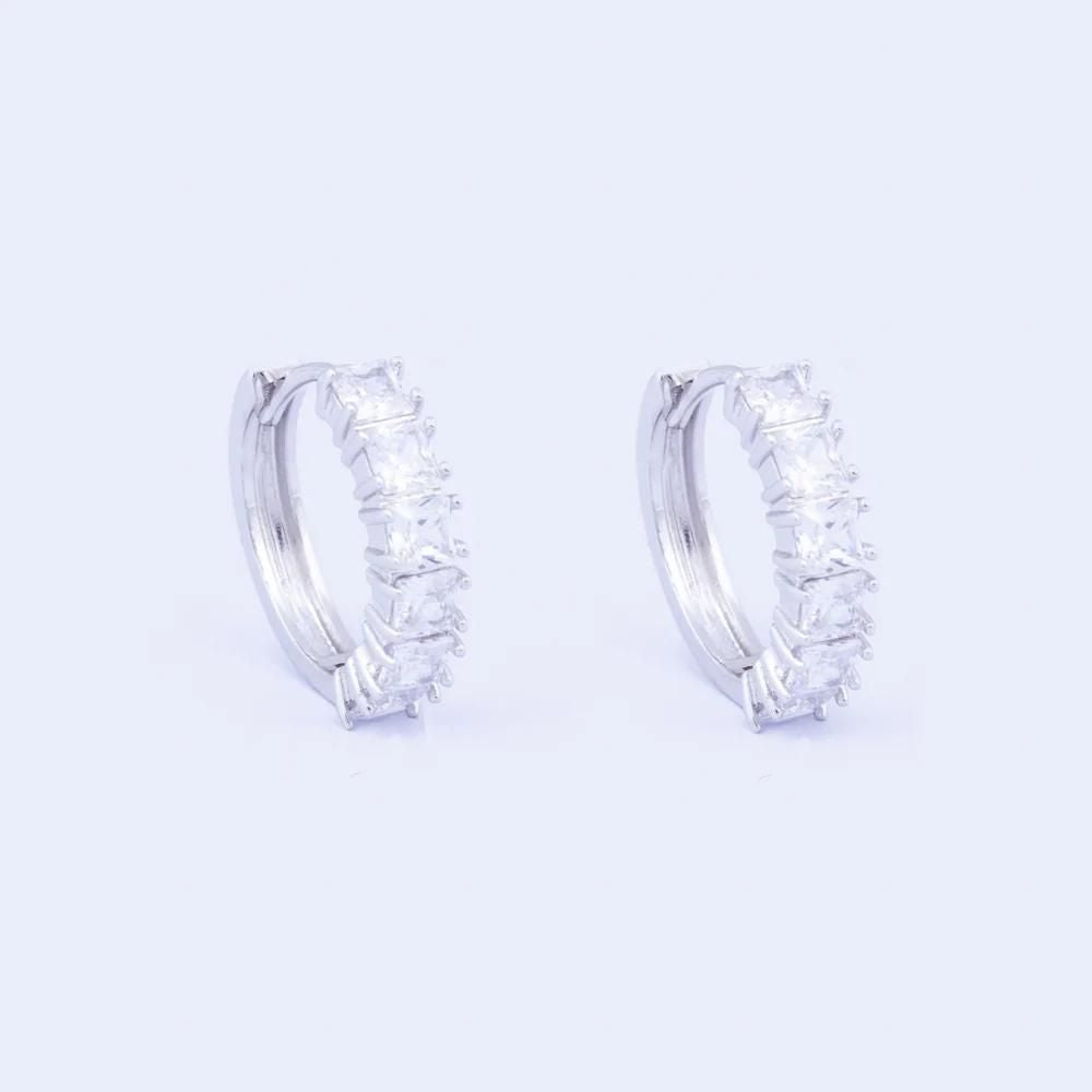 Knight & Day Classic Rhodium Hoop Earrings Classic style hoops embellished with clear CZ stones. Rhodium plating.