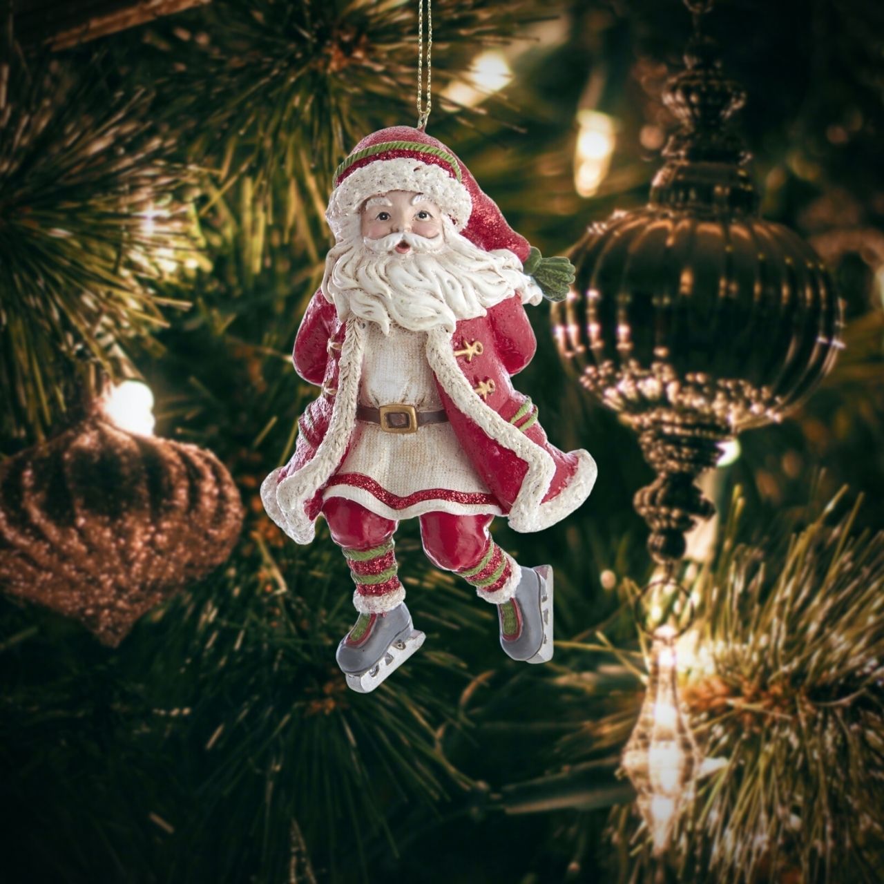 Kurt S Adler Skating Santa Christmas Hanging Ornament - Arm Back Skating Santa ornament from Kurt Adler is a charming addition to any holiday décor or Christmas tree. Santa wearing a red, white and green Santa outfit with a glittered hat and ice skates.