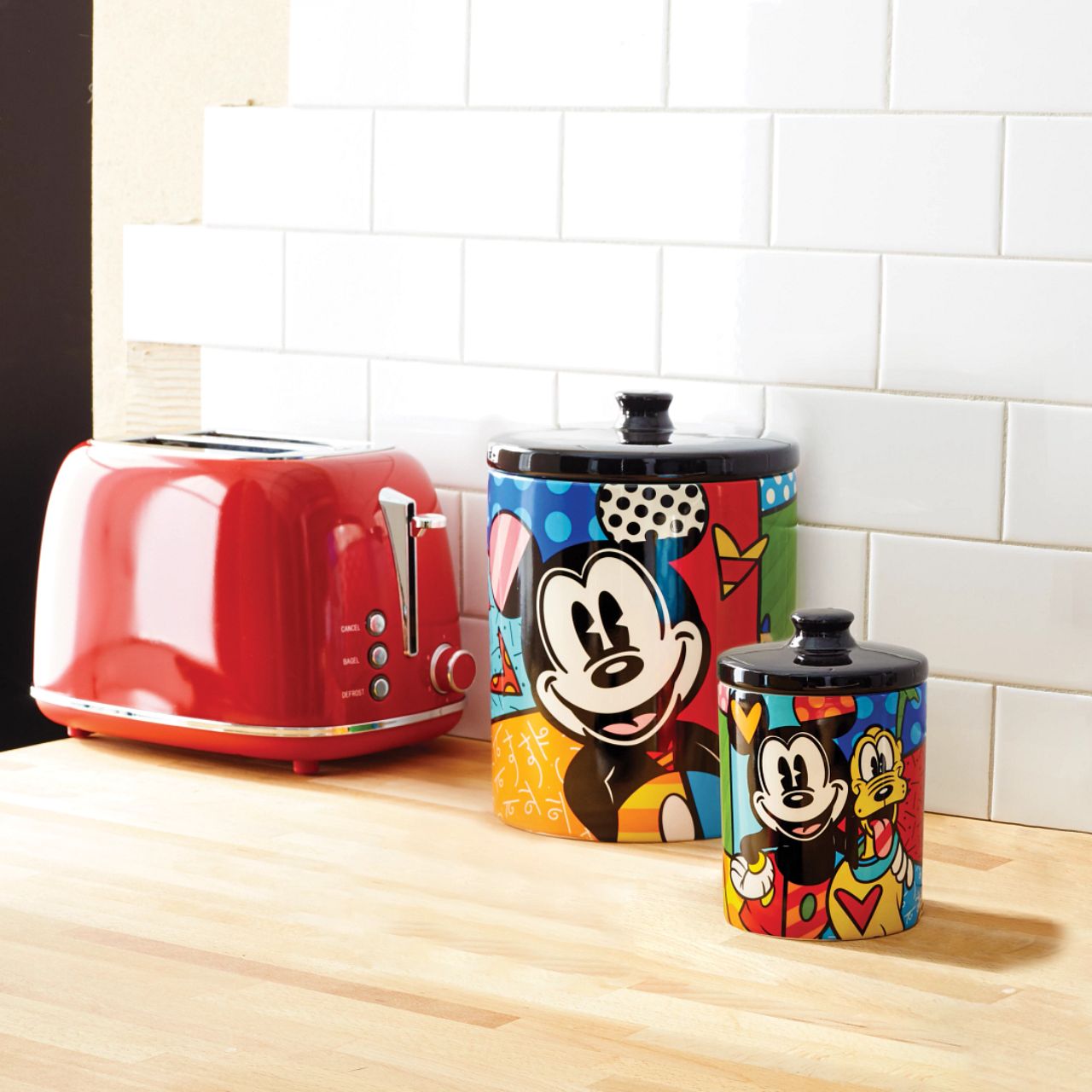 Mickey Mouse and Pluto Cookie Jar Small Mickey Mouse and his best pal Pluto are so full of life and love in this cookie jar canister designed by Romero Britto. Bright, bold, and full of friendship, it will be hard to avoid a sweet treat from such a sweet duo. Perfect for dog treats, coffee, flour, sugar or cookies.