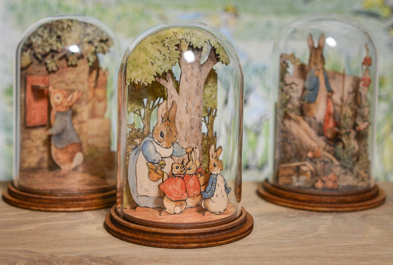 Mrs. Rabbit with Flopsy, Mopsy, Cotton Tail and Peter Wooden This charming Mrs. Rabbit and family wooden figurine has been intricately created and comes encased in a beautiful eco-friendly glass dome.
