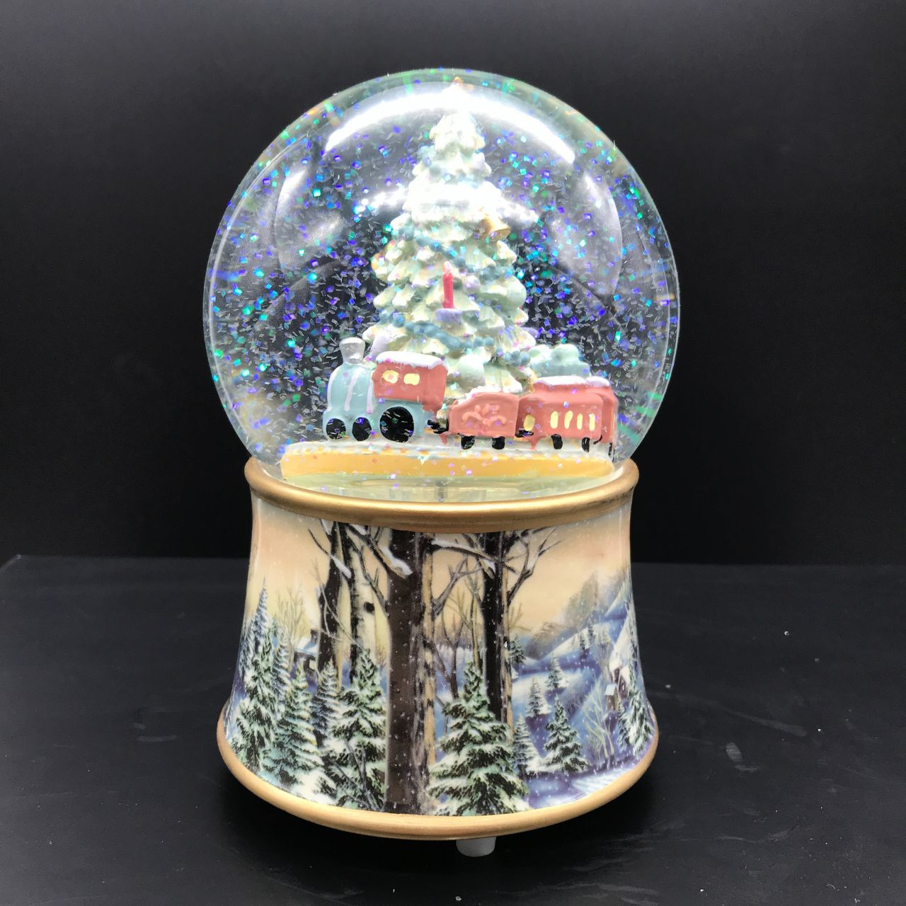 Music Box World Snow Globe Christmas Tree with Train Featuring festive scenes and characters, add charm and personality to your home this Christmas with our fabulous snow globes
