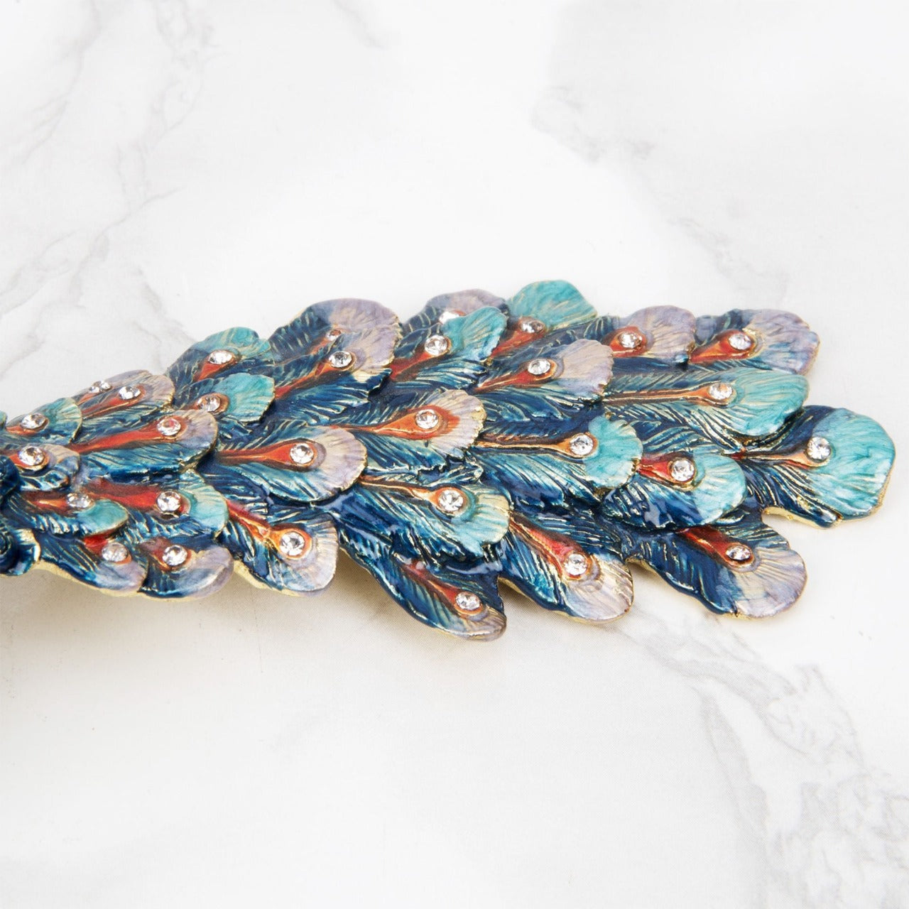 Treasured Trinkets - Peacock A beautiful, hand painted and crystal finished peacock trinket box from Treasured Trinkets. Painted with gorgeous blue plumage, this colourful trinket box is a wonderful ornament to complement a mantelpiece, bookcase or cabinet.