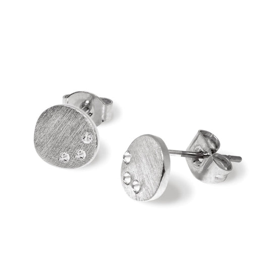 Tipperary Crystal Pebble Stud Earrings With CZ  These dainty stud earrings are crafted in brushed silver and consist of an organic pebble shape with three shimmering czs positioned organically along the perimeter. They secure comfortably with push backs.