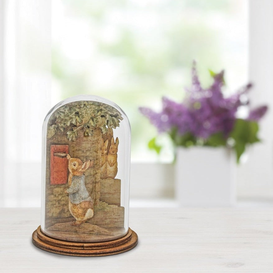 Peter Posting Letter Wooden Figurine This charming Peter Rabbit wooden figurine has been intricately created and comes encased in a beautiful eco-friendly glass dome.