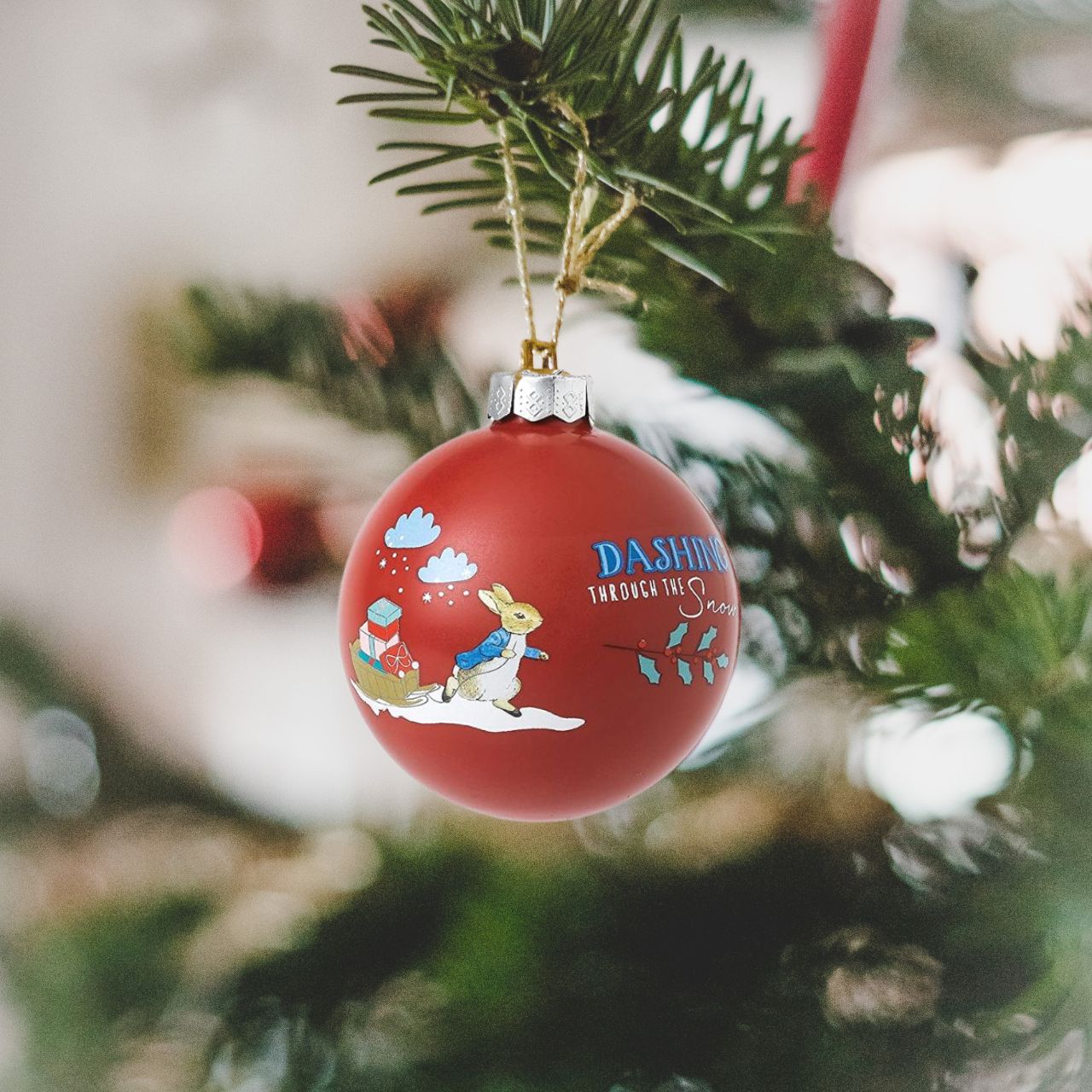 Beatrix Potter Peter Rabbit Merry Christmas Bauble  You'll be dashing through the snow with this lovely Peter Rabbit Merry Christmas Bauble. This bauble would make a treasured keepsake over the festive period, and would be take pride of place on the Christmas tree. Presented in a branded box.