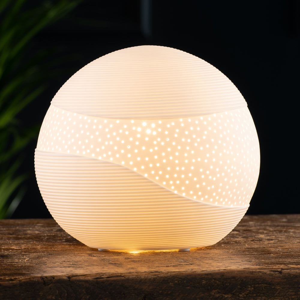 Saturn Luminaire by Belleek Living The Belleek Living Luminaire lamps emit a soft warm glow highlighting the delicate surface decoration and piercings, creating beautiful mood lighting for your home.