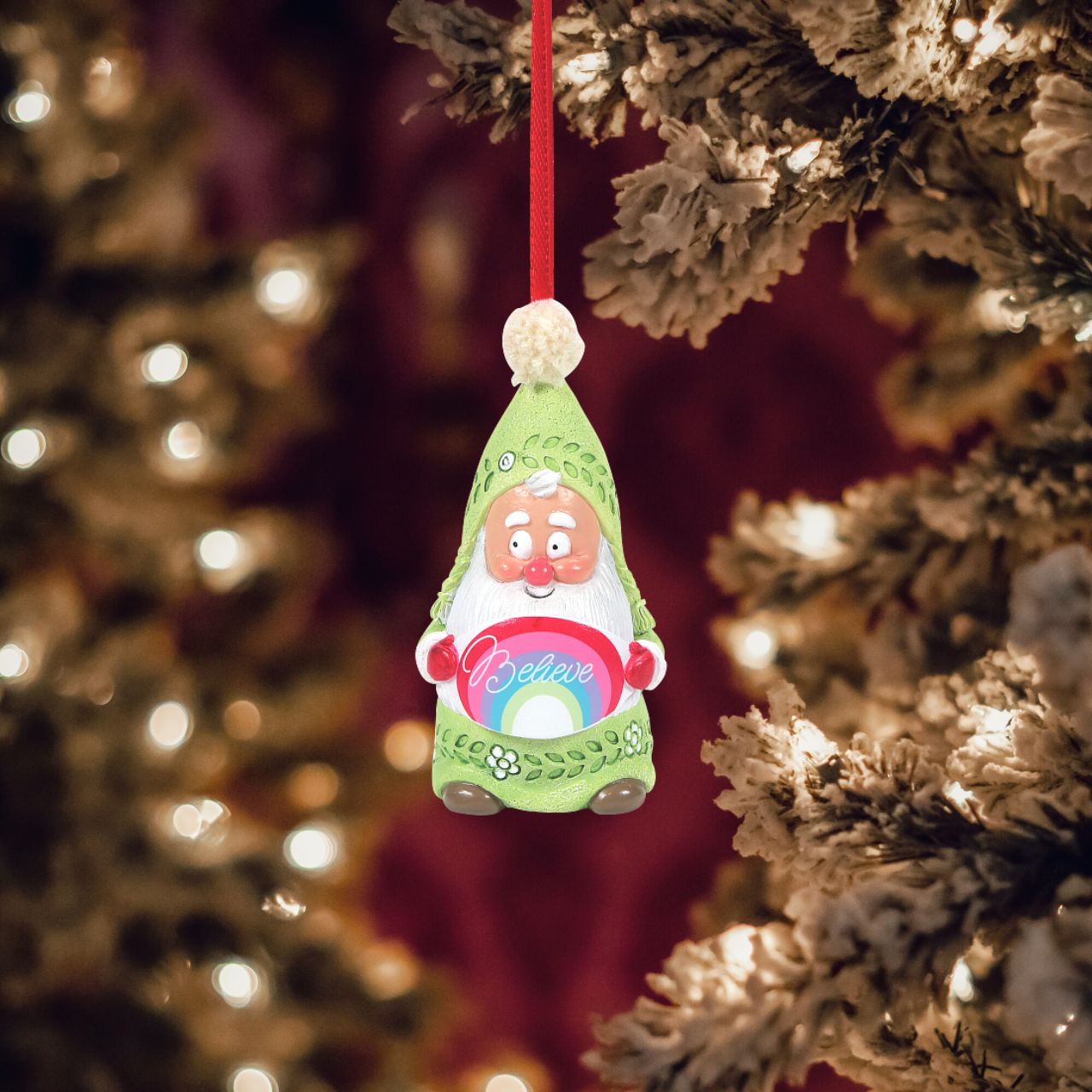 Department 56 Snowpinions Snow Gnome Believe Hanging Ornament This Snow Gnome is reminding you to Believe this Christmas time. He has been hand crafted using high quality cast stone and then hand painted by our talented artists. He is then completed with a real pom pom atop his hat. Perfect for hanging on your tree this festive season.