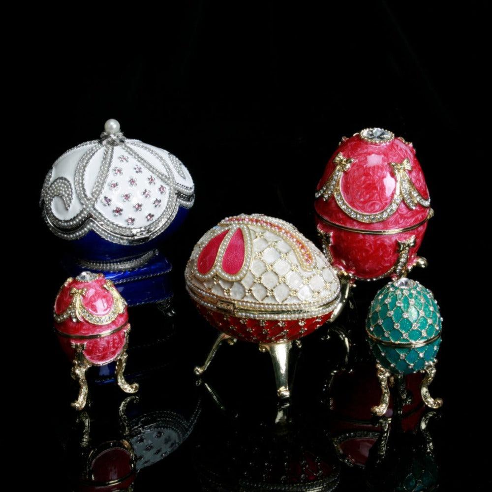 Treasured Trinkets Figurine - Small Turquoise Fabergé Egg A beautiful, hand painted and crystal finished Fabergé Egg style Trinket Box from Treasured Trinkets. Painted in a resplendent turquoise colour with stunning gold and crystal patterns, this trinket box is a wonderful ornament to complement a mantelpiece, bookcase or cabinet.