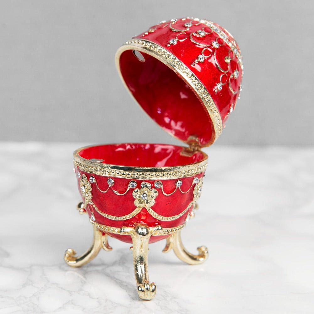 Treasured Trinkets - Large Red Fabergé Egg A beautiful, hand painted and crystal finished Fabergé egg trinket box from Treasured Trinkets. Painted in a majestic red colour with stunning gold and crystal patterns, this trinket box is a wonderful ornament to complement a mantelpiece, bookcase or cabinet.