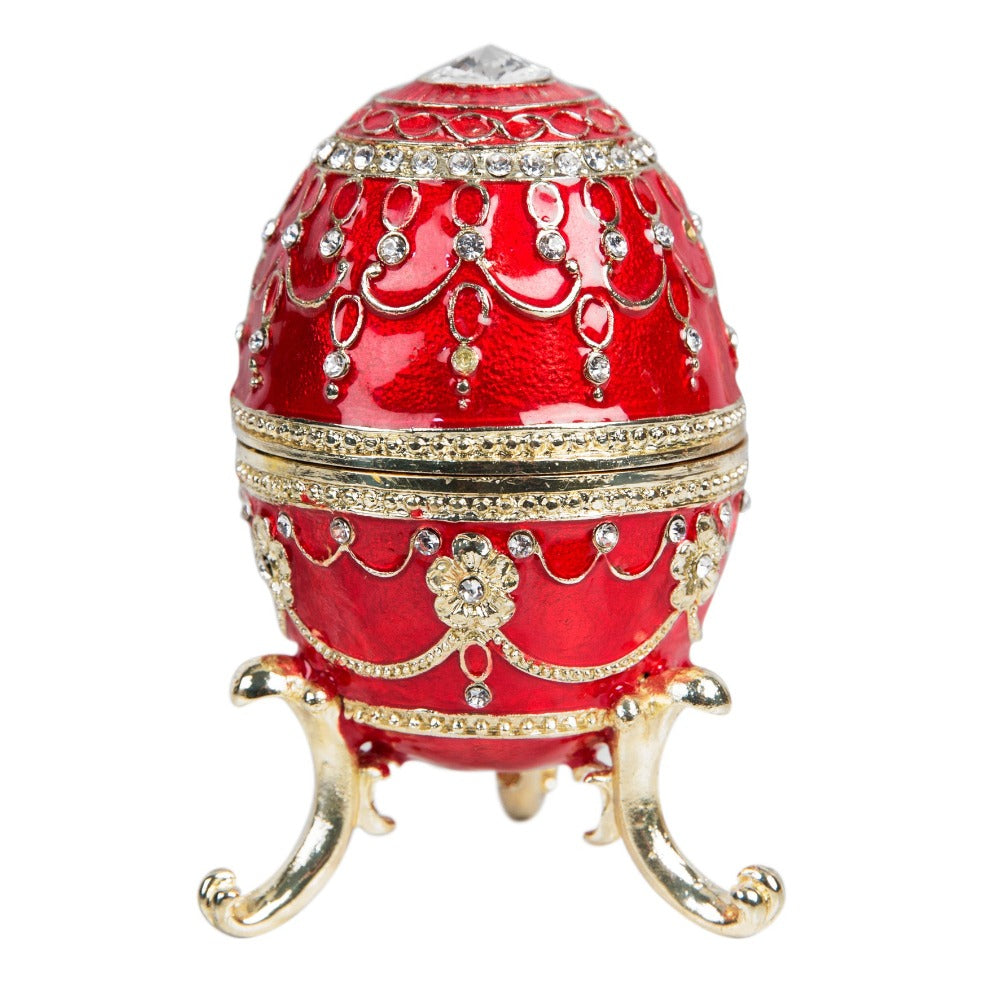 Treasured Trinkets - Large Red Fabergé Egg A beautiful, hand painted and crystal finished Fabergé egg trinket box from Treasured Trinkets. Painted in a majestic red colour with stunning gold and crystal patterns, this trinket box is a wonderful ornament to complement a mantelpiece, bookcase or cabinet.