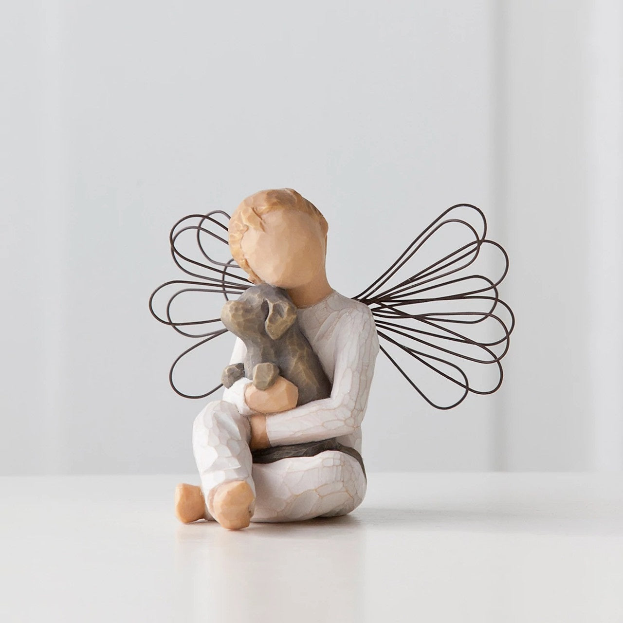Willow Tree Angel of Comfort A gift to express sympathy, comfort, remembrance and healing. A sweet little boy angel, hugging his best friend. Angel of Comfort is the only boy figure with wings.