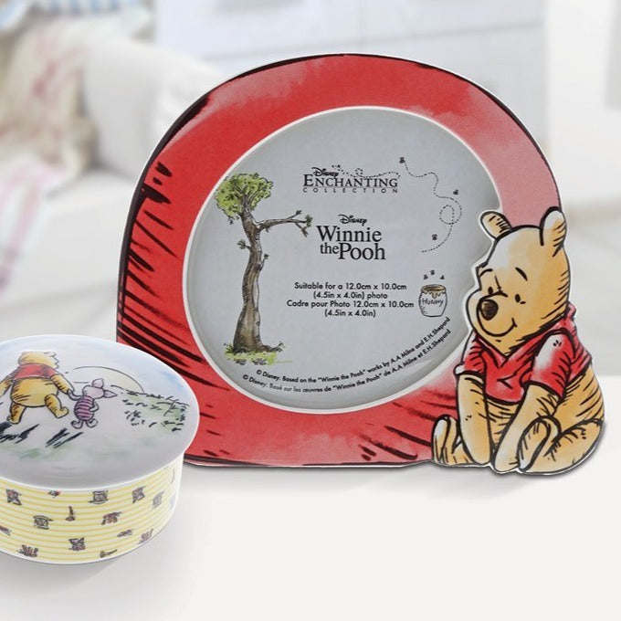 Disney Winnie The Pooh Photo Frame The adorable Pooh looks on lovingly at your treasured photo in this beautiful frame. The frame has been designed for you to showcase your your most treasured baby photos.