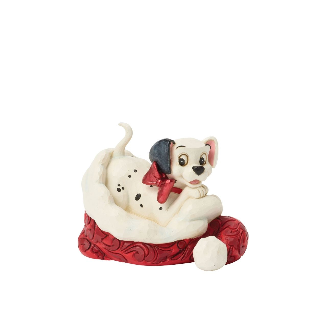 One of Disney's 101 playful dalmatians peeks out from a Santa hat in this adorable Jim Shore.