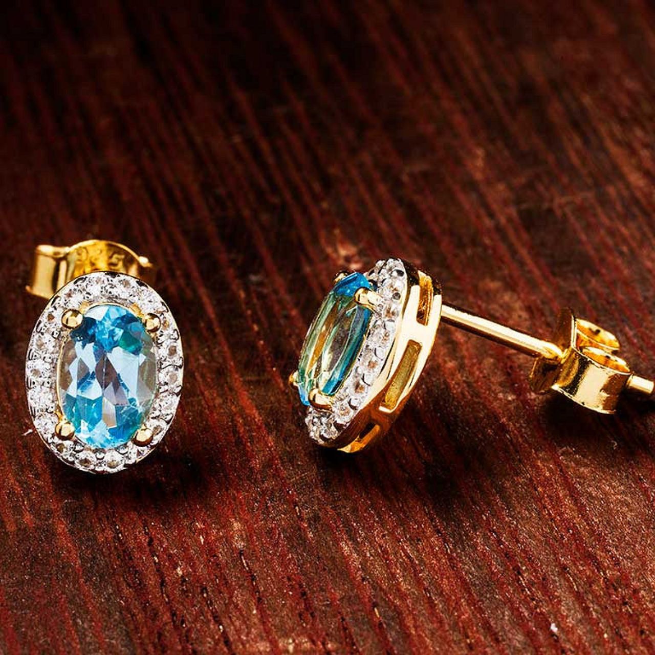 Elevate your collection with these ShanOre 14kt Gold Vermeil Earrings, featuring genuine blue topaz stones set within a delicate halo design.