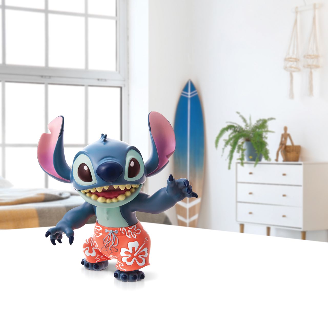 Aloha Stitch Figurine  Stitch, the troublesome alien from Disney's "Lilo and Stitch" strikes an fun pose in this handcrafted design, sculpted from cast stone with highly detailed shorts. Unique variations should be expected as this product is hand painted.