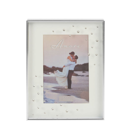 A beautiful silver plated box frame with 4" x 6" (10x15cm) aperture from the AMORE BY JULIANA® Wedding Day Collection. The frame features a crisp white mount and the glass is embellished with a spray of crystals. Complete with standing strut.