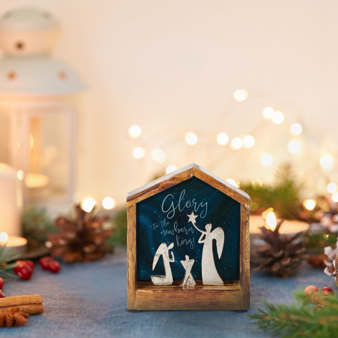Artist, Wendy Wiinanen, crafts memorable and miniature traditional Christmas moments from mango wood and aluminium. This enchanting display places two angels in a wooden stable peering over a cradle.