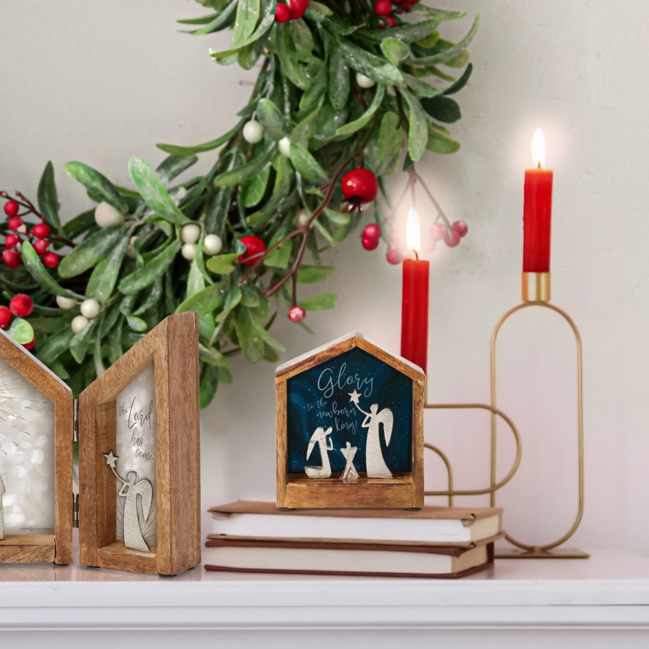 Artist, Wendy Wiinanen, crafts memorable and miniature traditional Christmas moments from mango wood and aluminium. This enchanting display places two angels in a wooden stable peering over a cradle.