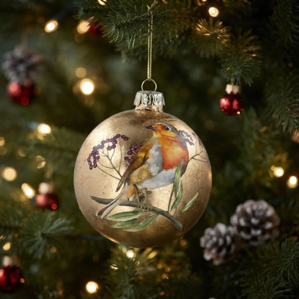 This stunning antique gold glass Christmas bauble from Gisela Graham features a delightful robin perched on top, adding a touch of festive charm to your decorations. The intricate design provides an elegant and unique look to any holiday display.