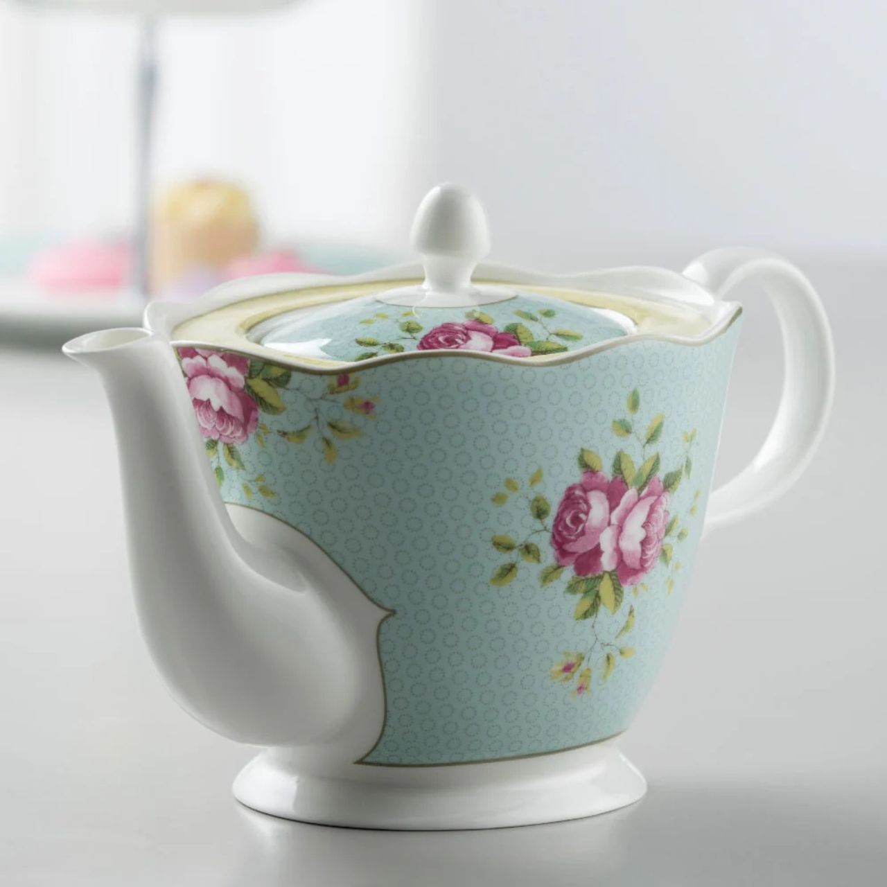 Teapot with floral design on a light blue background