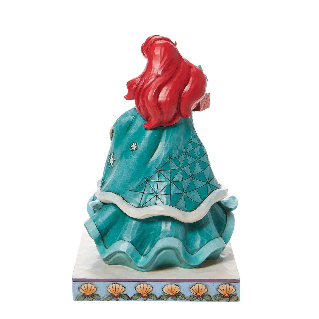 Jim Shore Ariel Little Mermaid with Gifts Figurine - Gifts of Song  In a brilliant blue dress, Ariel is a vision of beauty and gratitude in this lovely Jim Shore statuette. Carrying gifts and wearing a broach of holly, the princess delivers presents to all those Under the Sea. Flounder and Sebastian grace the base. Hand painted and hand sculpted from high quality cast stone.