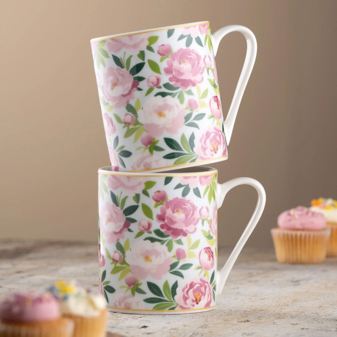 The Pink Peony Mugs Pair captures the beauty of soft blush florals on fine china, adding a delicate charm to tea or coffee moments. Presented in elegant gift packaging, they make a thoughtful gift or a lovely addition to your home.