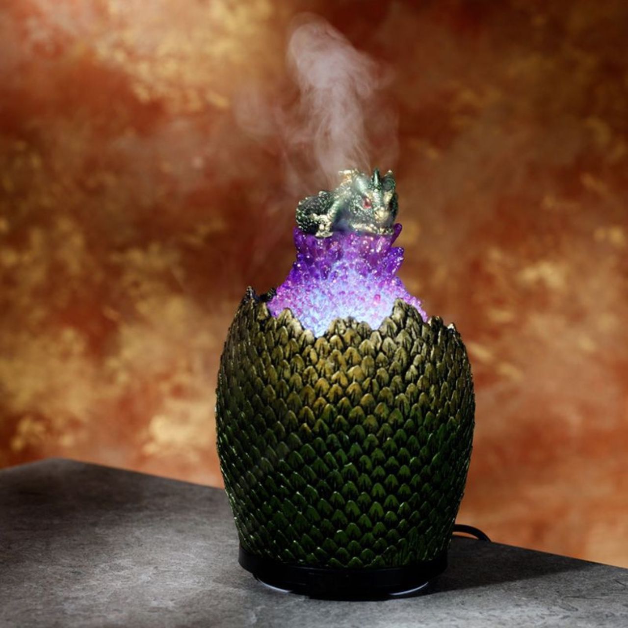 Baby Dragon Crystal Egg USB Ultrasonic Misting Aroma Diffuser  - Material: Resin, Plastic and Metal - Diffuser Type: Ultrasonic - Our diffusers use ultrasonic vibrations that silently break apart the water and oils creating a fine mist. There are no fans or heat used in this process.