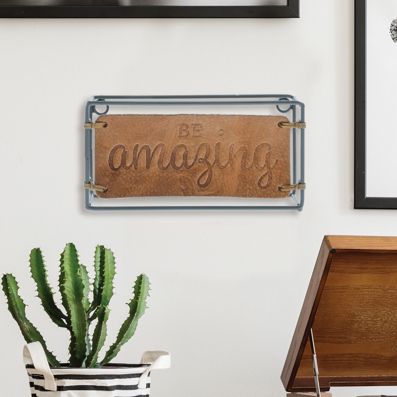 Be Amazing Plaque  The Impressions collection expresses appreciation of home and family in enduring leather creations. The Be Amazing Plaque adorns the home with an inspiring message. Made of iron and leather.