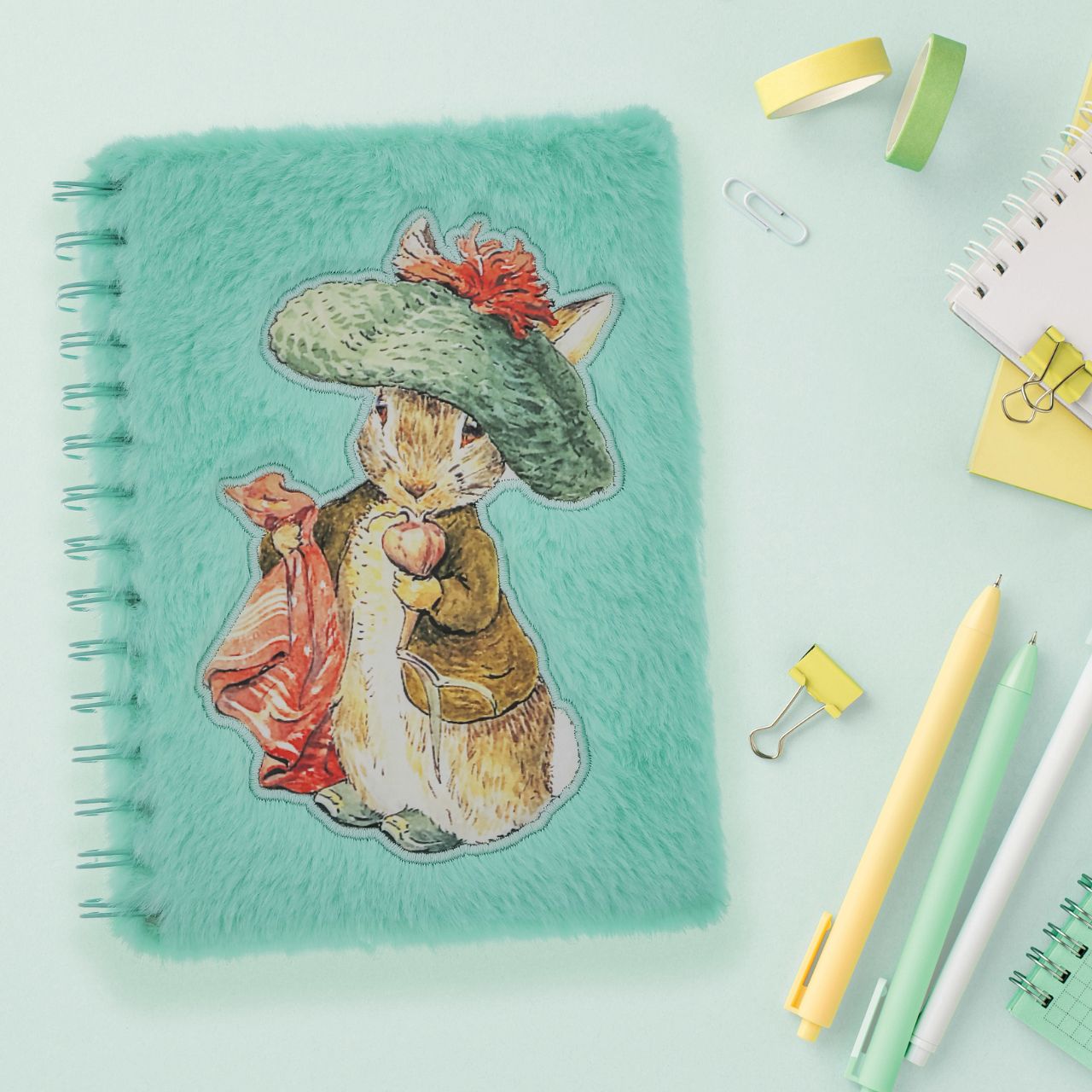 Step into the enchanting world of Beatrix Potter with this delightful Benjamin Bunny Notebook, adorned with a plush cover that feels as soft as a bunny's fur.