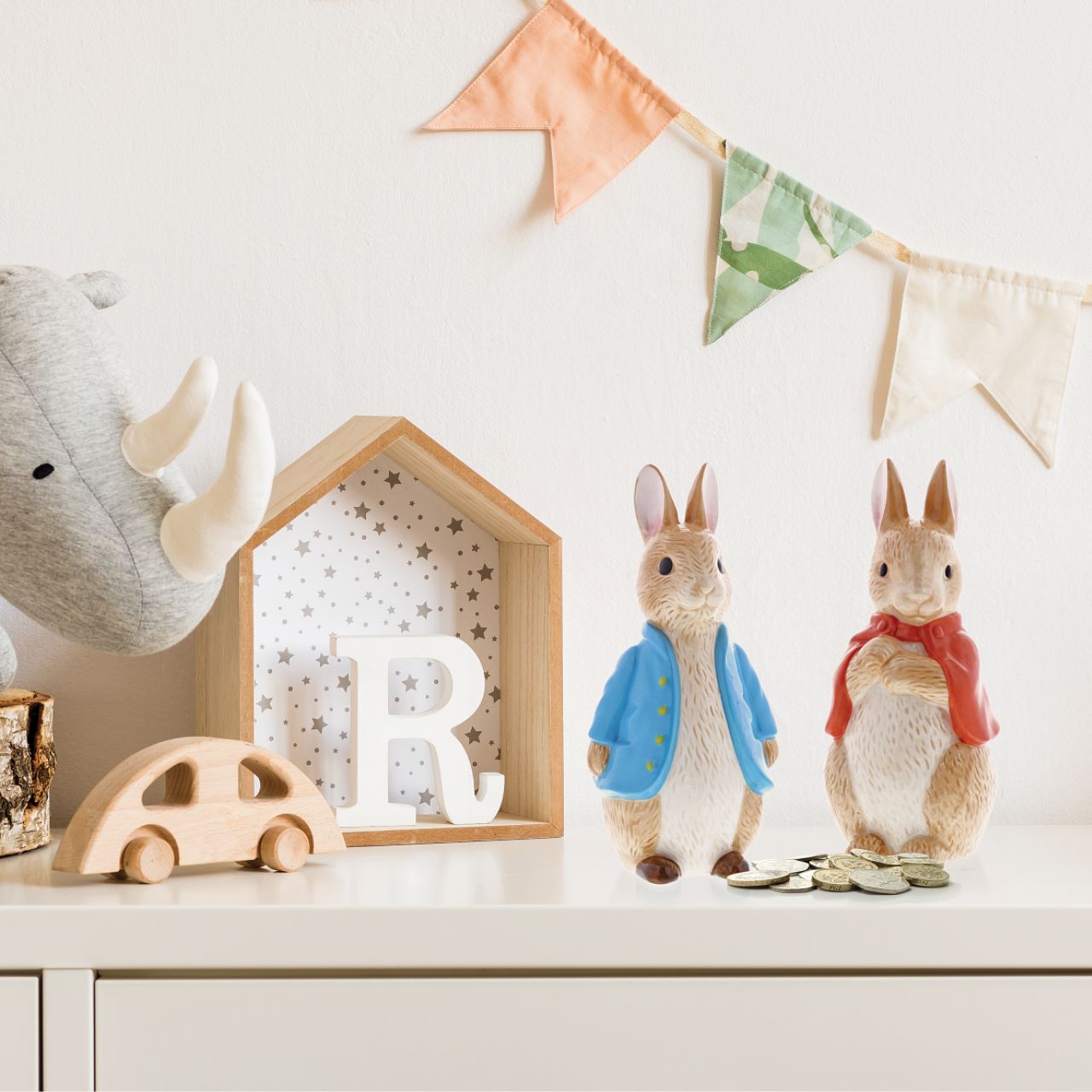 Beatrix Potter Flopsy Sculpted Money Bank  This delightful and charming Flopsy shaped money box would make an ideal christening gift, for collectors and Peter Rabbit fans, both young and old. The artwork is taken from the original illustrations from the Beatrix Potter stories.