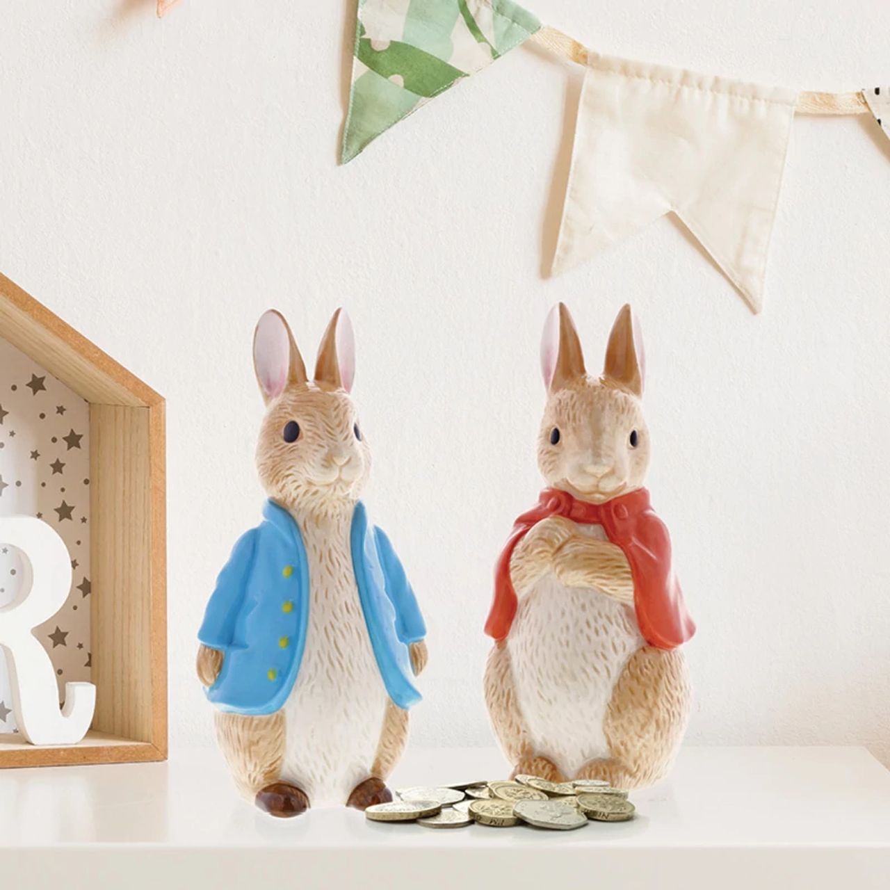 Beatrix Potter Flopsy Sculpted Money Bank  This delightful and charming Flopsy shaped money box would make an ideal christening gift, for collectors and Peter Rabbit fans, both young and old. The artwork is taken from the original illustrations from the Beatrix Potter stories.