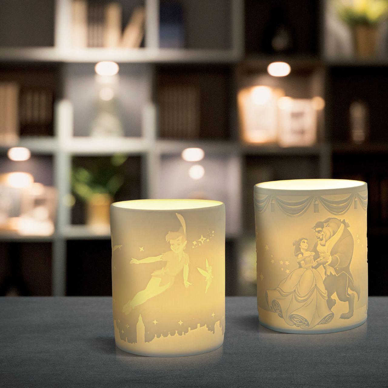 Disney Beauty Within Beauty and The Beast Tea Light Holder  Watch as Beauty and The Beast flicker around your room when you light the LED candle. The Belle and her Prince along with the enchanted rose are etched into the thin translucent porcelain which will radiate a warm light when lit at night. Perfect Disney addition to any home décor.