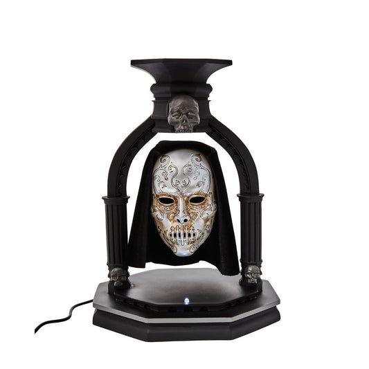 NEW and exclusively from Enesco is the Bellatrix Lestrange Levitating Death Eater Mask. This piece works using polarized magnets to hold the mask in place, floating in mid air with an LED light indicating when the magnet is activated.