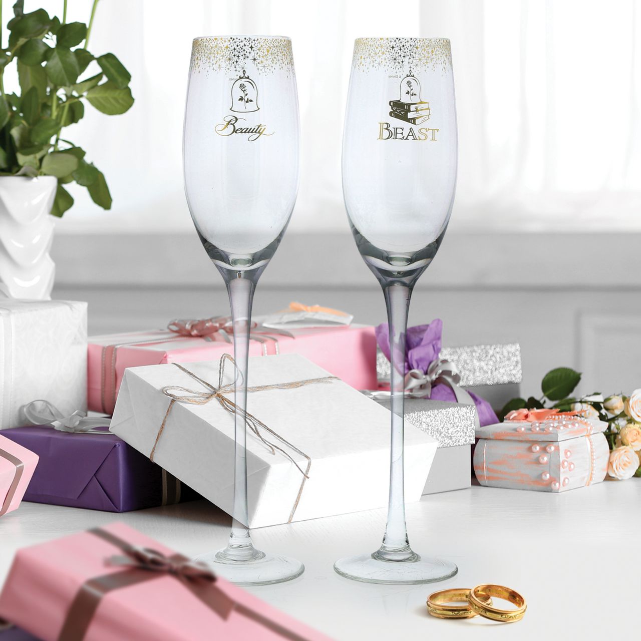 Beauty and the Beast Belle Wedding Toasting Glasses  Raise a toast in Disney style with our Beauty and the Beast glasses. The set of two glasses are the perfect gift and keepsake for the happy couple to use for their fairy tale wedding. Packed in a Disney branded window gift box.