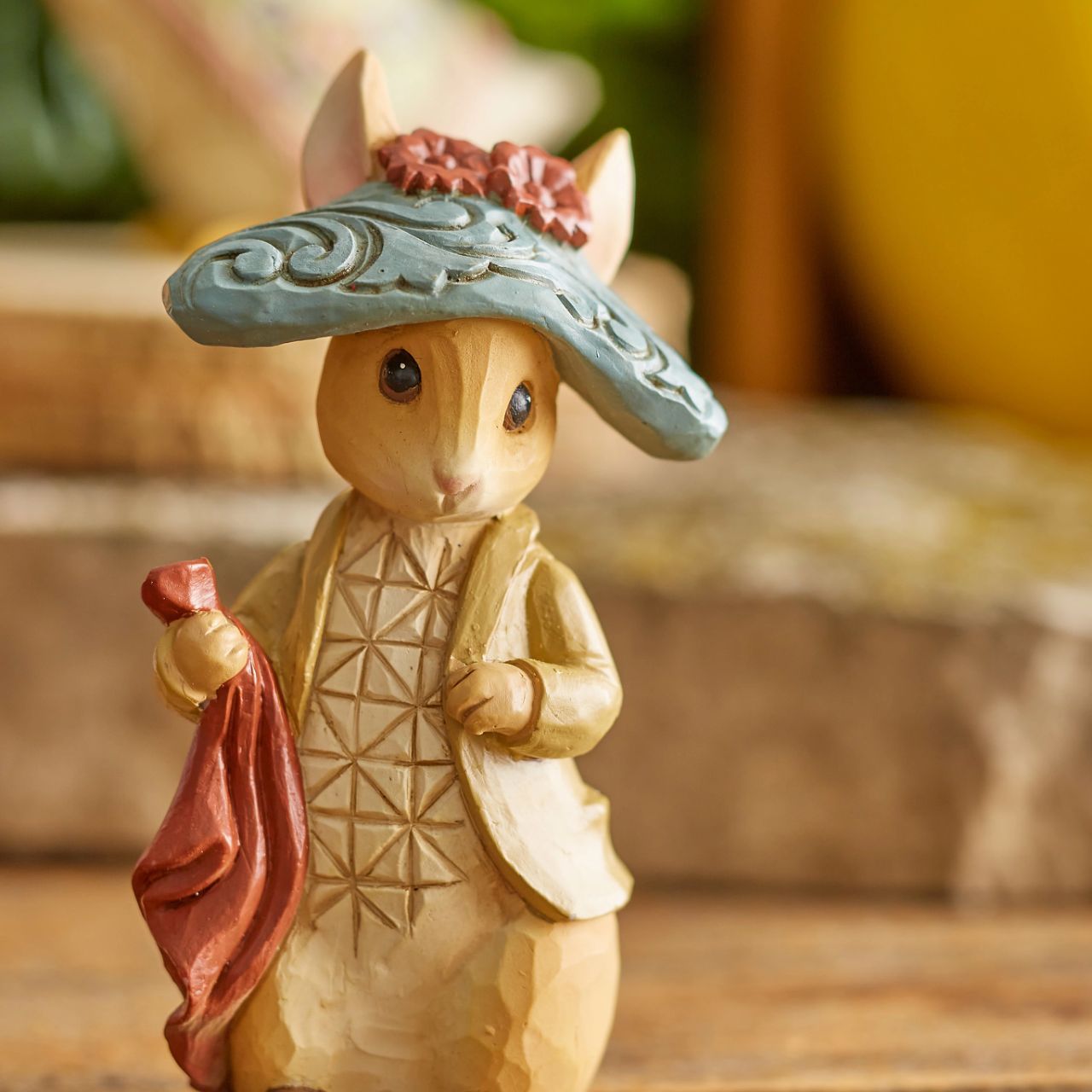 Benjamin Bunny, Peter Rabbit's lovable cousin, brings a flower for you and kindness to your home. Wearing his characteristic hat, the little bunny waits patiently for the next adventure. Exquisitely crafted by Jim Shore, Benjamin boasts with beauty.