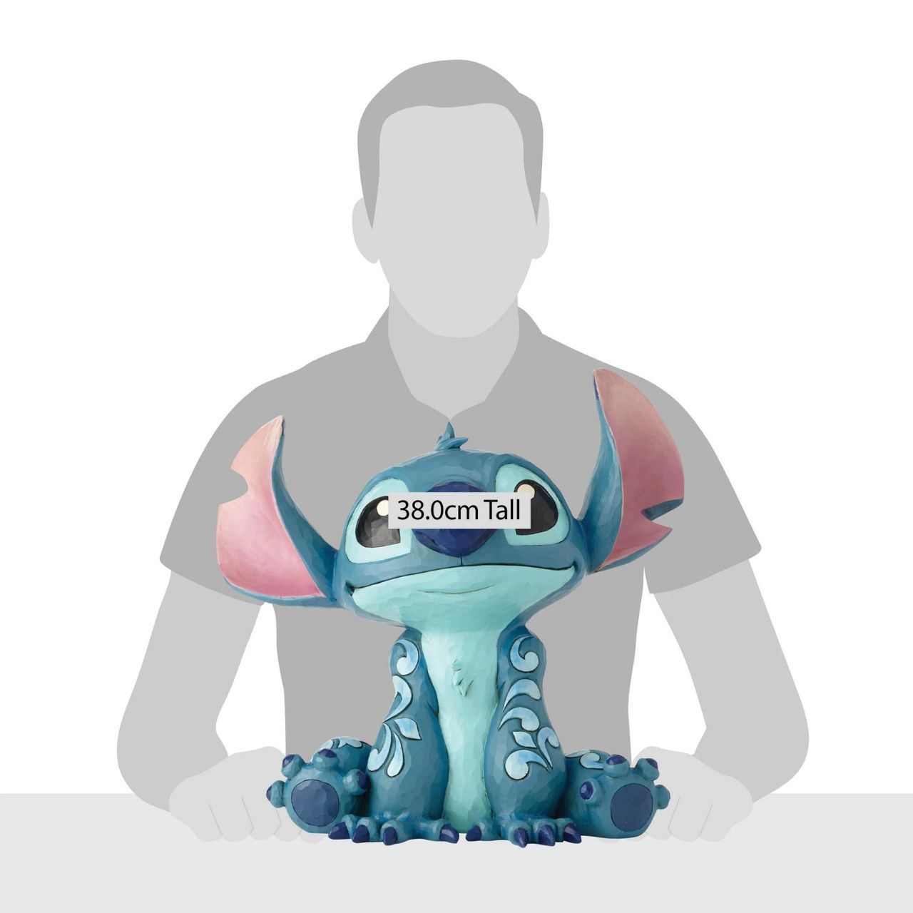 Disney Traditions Big Trouble Stitch Statement Figurine  It's hard to believe this sweet face could be behind so much chaos| Stitch, the troublesome alien from Disney's "Lilo and Stitch" strikes an innocent pose in this handcrafted design, sculpted from cast stone and hand-painted with whimsical folk-art details.