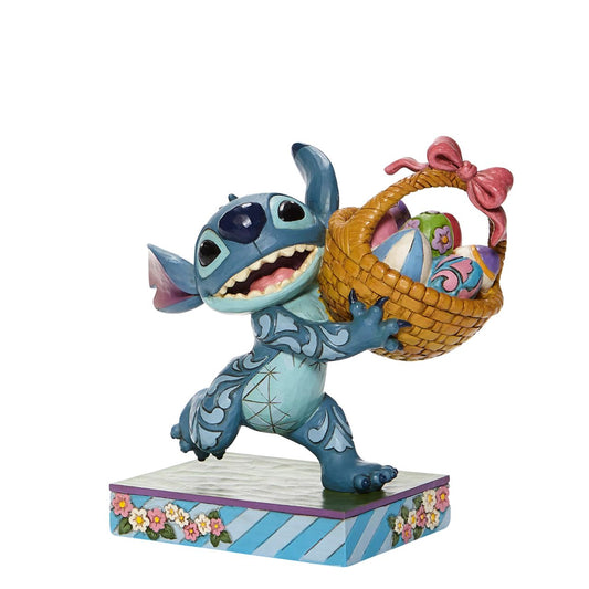 Jim Shore Bizarre Bunny - Stitch Running off with Easter Basket Figurine  Mischievous Stitch has taken off with your Easter basket so try and catch him if you can or entice him with his favourite, "Coconut Cake"| Designed by Jim Shore, this fun-loving Disney Traditions piece is hand-painted in cheery springtime hues.