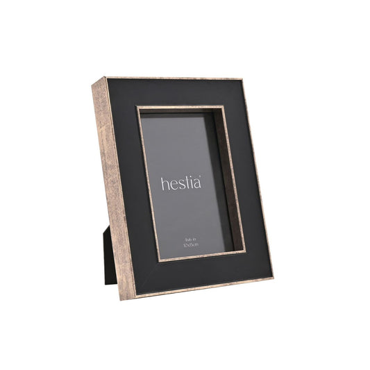Introduce a touch of sophistication to your home with the Hestia Black Box Frame with Gold Edge. This striking piece, with its black matte finish and metallic gold border, gives your memories a chic and modern backdrop.