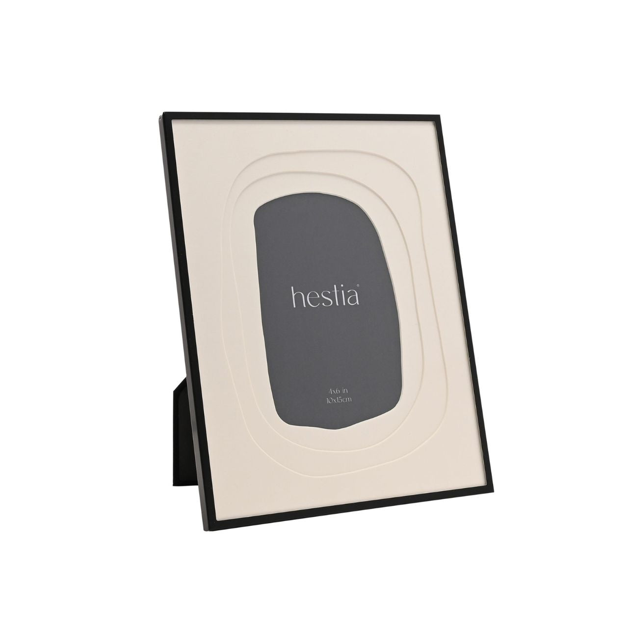 The Hestia Black Aluminium Photo Frame with Layered Mount is a striking piece for displaying memories. Its sleek black aluminium frame contrasts with the crisp white matte, highlighting the cherished 4x6 inch photograph at its centre.