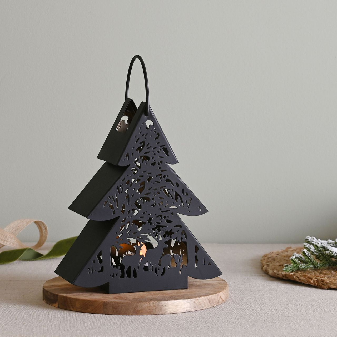 Black Tree Lantern Small  A small black tree lantern by THE SEASONAL GIFT CO®.  This enchanting lantern glistens with festive charm throughout the Christmas period.